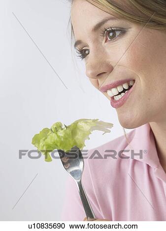 Stock Image - Woman with salat and fork. Fotosearch