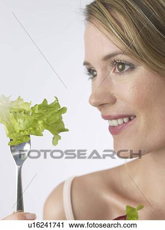 Stock Image - Woman with salat and fork. Fotosearch