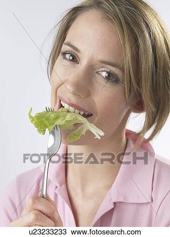 Stock Image - Woman with salat and fork. Fotosearch