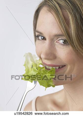 Stock Photograph - Woman with salat and fork. Fotosearch