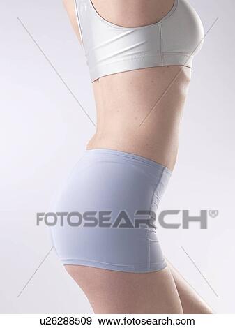 Stock Photo - Woman with sportswear, waist and buttocks. Fotosearch