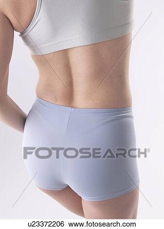 Stock Photograph - Woman with sportswear, waist and buttocks. Fotosearch