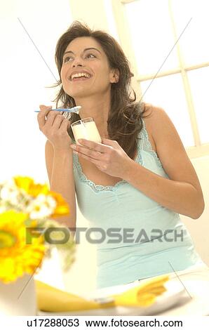 Stock Image - Woman with yoghurt in a glass. Fotosearch