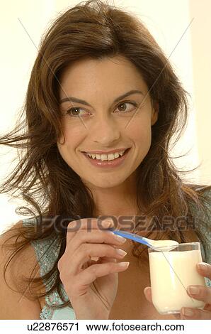 Woman with yoghurt in a glass View Large Photo Image Stock Image - Woman with yoghurt in a glass. Fotosearch
