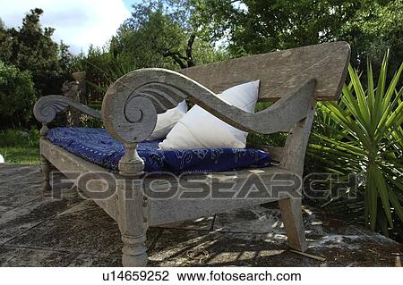 Stock Image - Wooden bench with cushions. Fotosearch