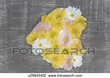 Stock Image - Wooden plank with heart of blossoms. Fotosearch