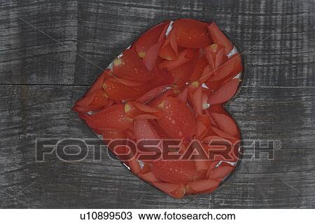 Stock Image - Wooden plank with heart of petals. Fotosearch