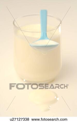 Yoghurt in a glass and a spoon View Large Photo Image Stock Photo - Yoghurt in a glass and a spoon. Fotosearch