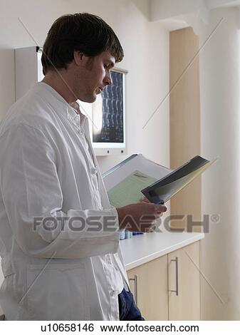 Stock Photograph - Young doctor with x-ray. Fotosearch