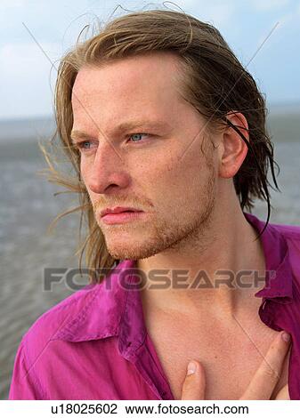 Stock Image - Young man on the beach. Fotosearch