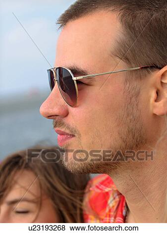 Stock Photo - Young man with sunglasses. Fotosearch
