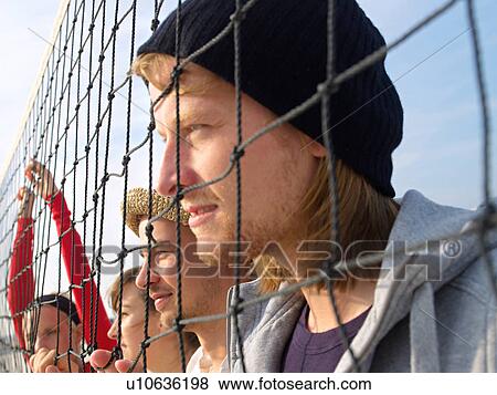 Stock Photo - Young people at the beachball net. Fotosearch