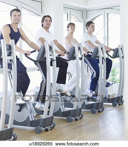 Stock Photography - young people on fitness bikes. Fotosearch
