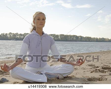 Young woman doing yoga exercise o the beach View Large Photo Image Stock Photo - Young woman doing yoga exercise o the beach. Fotosearch