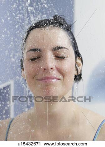 Stock Image - young woman in the shower. Fotosearch