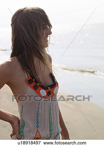 Young woman on the beach in a summer dress View Large Photo Image Stock Photo - Young woman on the beach in a summer dress. Fotosearch