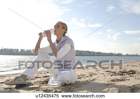 Young woman on the beach View Large Photo Image Stock Photography - Young woman on the beach. Fotosearch