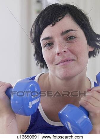 young woman with blue dumbbells View Large Photo Image Stock Image - young woman with blue dumbbells. Fotosearch