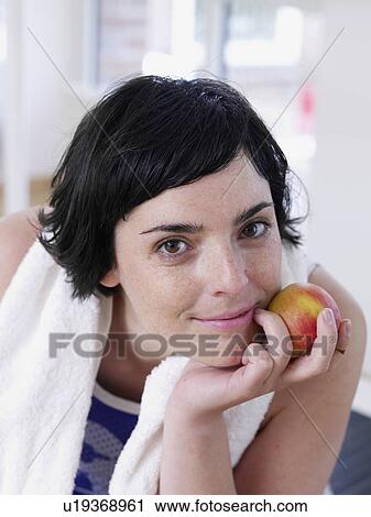 Stock Image - ypung woman in a fitnessstudio. Fotosearch