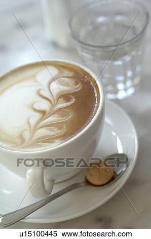 Stock Photography - A cup of white coffee with nice pattern. Fotosearch