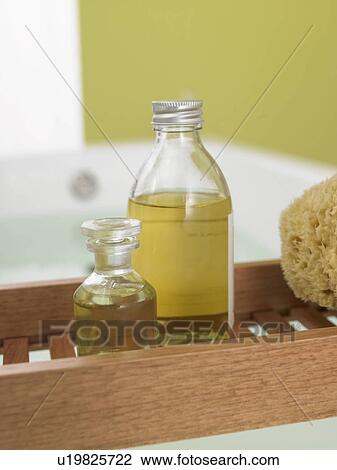 Stock Image - Bath oil on the bathtub tray. Fotosearch