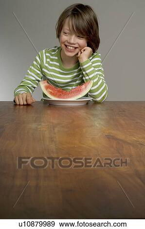 Stock Photo - Boy eating water melon. Fotosearch