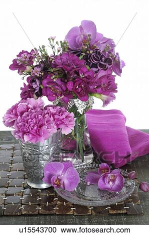 Stock Image - Bunch of flowers with orchids and freesia in vase. Fotosearch