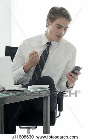 Stock Image - Business man clenching his fist. Fotosearch