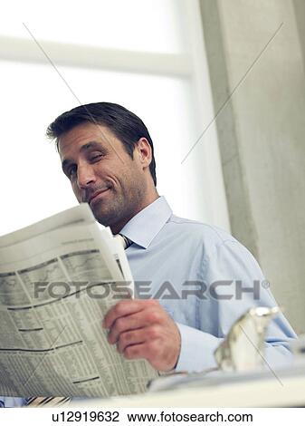 Business man reading newspaper View Large Photo Image Stock Image - Business man reading newspaper. Fotosearch