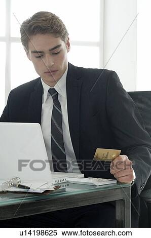 Stock Photography - Business man with credit card. Fotosearch