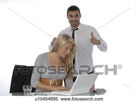 Businessman and woman with laptop at desk View Large Photo Image Stock Photography - Businessman and woman with laptop at desk. Fotosearch
