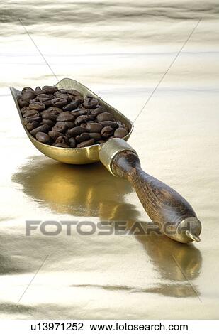 Stock Image - Coffee beans on gold foil. Fotosearch