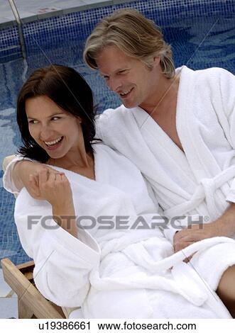 Couple at the swimming pool in a bathrobe View Large Photo Image Stock Image - Couple at the swimming pool in a bathrobe. Fotosearch