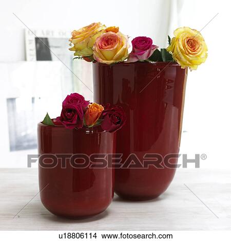 Picture - Dark red glass vases with roses. Fotosearch
