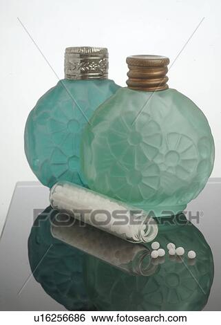 Stock Photograph - Globules in front of two green glass bottles. Fotosearch