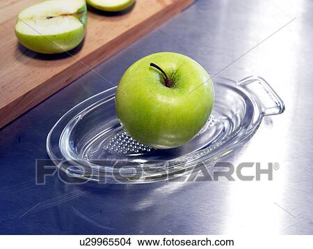 Picture - Grater made of glass with an apple. Fotosearch