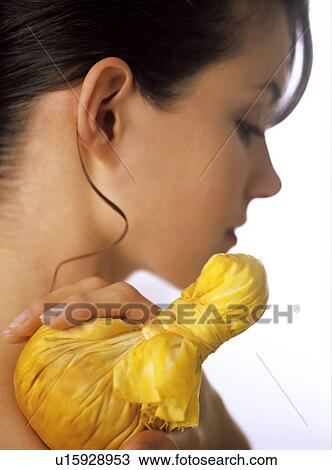 Stock Image - Hot herb compress with Curcuma for muscle tenseness. Fotosearch