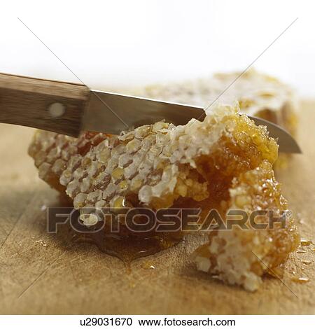 Knife cutting honeycomb View Large Photo Image Stock Image - Knife cutting honeycomb. Fotosearch