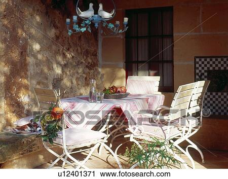 Stock Image - Layed table in patio. Fotosearch