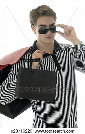 Stock Photo - Man with sunglasses with paper shopping bags. Fotosearch