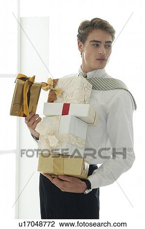 Man with wrapped gifts View Large Photo Image Stock Image - Man with wrapped gifts. Fotosearch