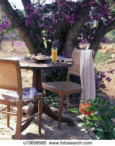 Stock Photography - Mediterranean scene with bistro table and chairs. Fotosearch