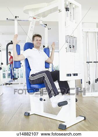 Stock Photo - One man exercising in rehab. Fotosearch