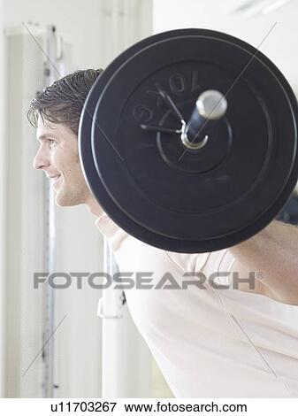 One man exercising with barbell in the gym View Large Photo Image Stock Photo - One man exercising with barbell in the gym. Fotosearch