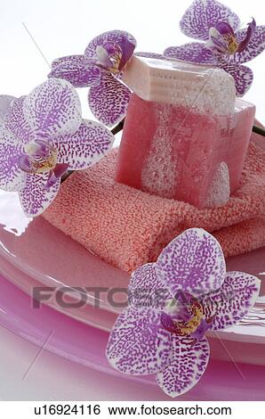 Stock Photograph - Orchid blossoms, soap and a towel. Fotosearch