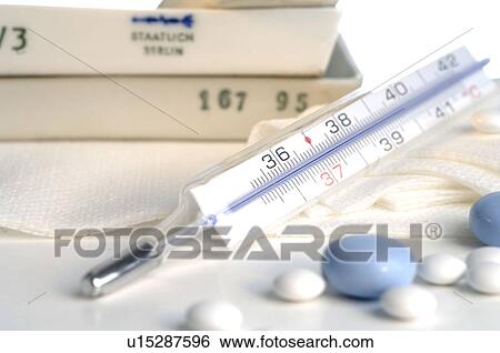 Stock Photograph - Pills and clinical thermometer. Fotosearch