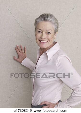 Senior citizen in business wear smiling at camera View Large Photo Image Stock Photo - Senior citizen in business wear smiling at camera. Fotosearch
