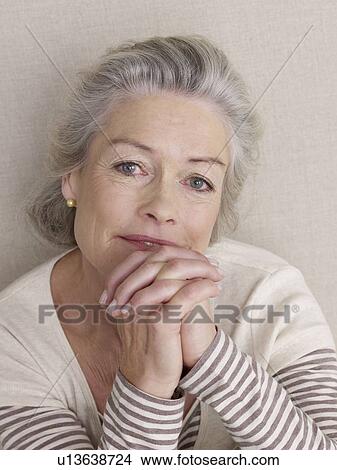 Picture - Senior citizen in sport wear with folded hands. Fotosearch