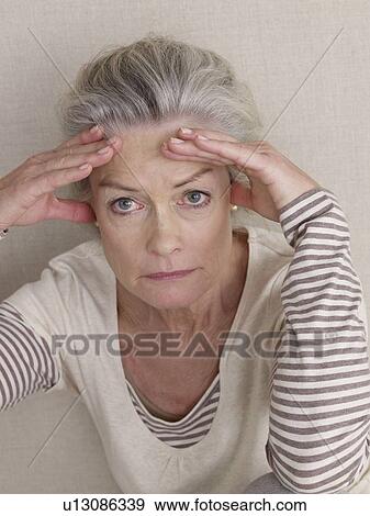 Senior citizen in sport wear with headache View Large Photo Image Stock Photo - Senior citizen in sport wear with headache. Fotosearch