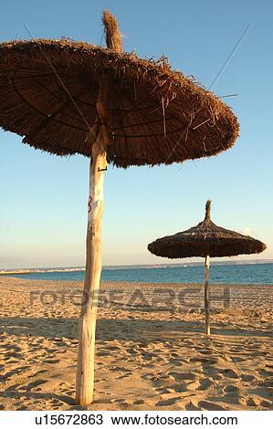 Sun shades made of straw on the beach View Large Photo Image Stock Image - Sun shades made of straw on the beach. Fotosearch